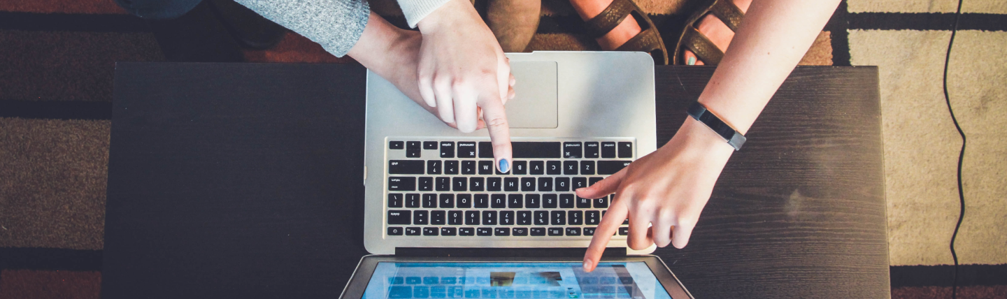 People pointing at computer